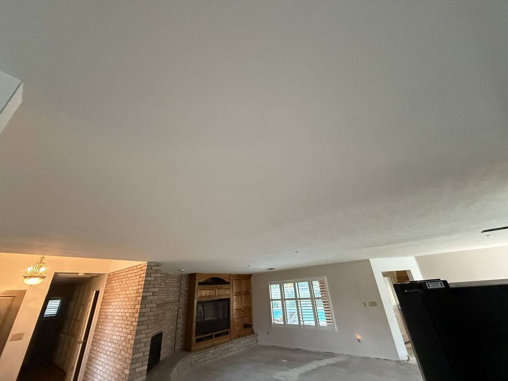 Warm finished interior with smooth ceiling and fireplace